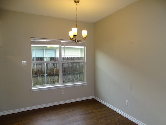 2013 Alanbrooke Dr, Fort Worth, TX 76140 - spare room with a chandelier, baseboards, and dark wood-style flooring