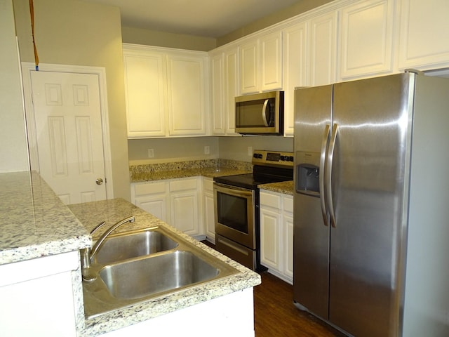 2013 Alanbrooke Dr, Fort Worth, TX 76140 - kitchen with stainless steel appliances, a sink, white cabinetry, dark wood-style flooring, and light countertops