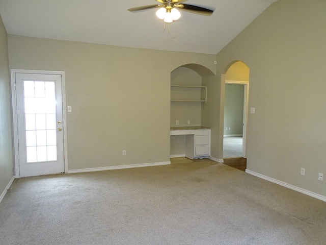 2013 Alanbrooke Dr, Fort Worth, TX 76140 - unfurnished living room featuring a ceiling fan, carpet flooring, arched walkways, vaulted ceiling, and baseboards