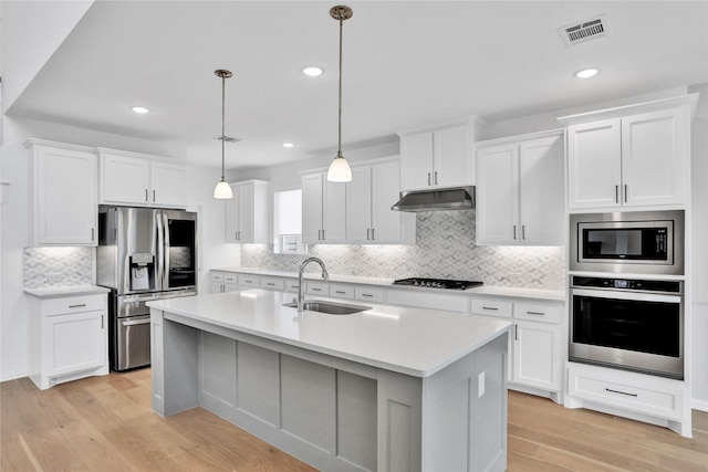545 Oakmoss St, Little Elm, TX 76227 - kitchen featuring stainless steel appliances, backsplash, light wood-type flooring, light countertops, and recessed lighting
