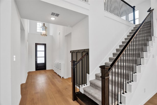 545 Oakmoss St, Little Elm, TX 76227 - entrance foyer with a towering ceiling, stairs, wood finished floors, and a chandelier