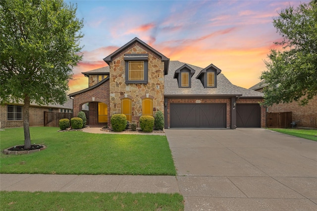 1021 Tara Dr, Burleson, TX 76028 - view of front of house with an attached garage, concrete driveway, brick siding, and stone siding