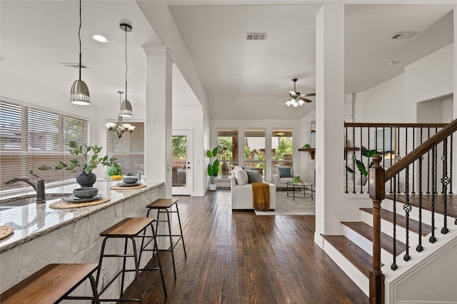 1021 Tara Dr, Burleson, TX 76028 - kitchen with ceiling fan, plenty of natural light, dark wood finished floors, and a breakfast bar