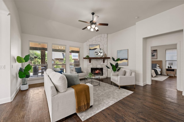 1021 Tara Dr, Burleson, TX 76028 - living area featuring vaulted ceiling, a stone fireplace, ceiling fan, and dark wood finished floors