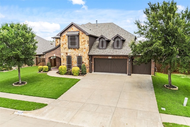 1021 Tara Dr, Burleson, TX 76028 - french provincial home with a shingled roof, stone siding, a garage, concrete driveway, and brick siding