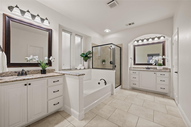 1021 Tara Dr, Burleson, TX 76028 - bathroom featuring a stall shower, a bath, two vanities, and tile patterned flooring