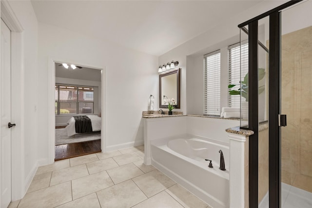 1021 Tara Dr, Burleson, TX 76028 - ensuite bathroom featuring a bath, a shower stall, and tile patterned flooring