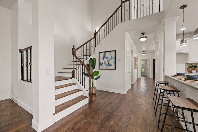 1021 Tara Dr, Burleson, TX 76028 - entrance foyer with dark wood-type flooring, a towering ceiling, and stairs