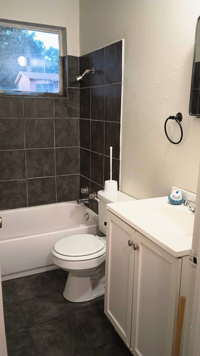 1214 Adelaide Dr, Dallas, TX 75216 - bathroom featuring vanity, toilet, washtub / shower combination, tile patterned flooring, and a textured wall