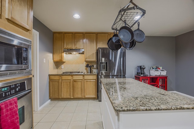 3428 Baby Doe Ct, Fort Worth, TX 76137 - kitchen featuring appliances with stainless steel finishes, under cabinet range hood, tasteful backsplash, a center island, and light tile patterned floors