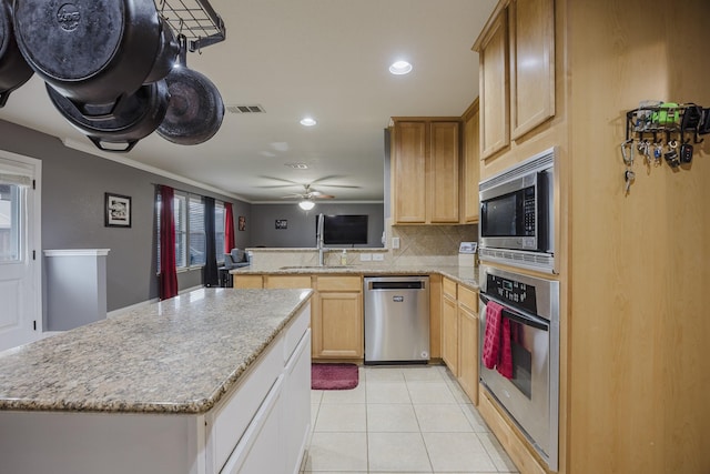 3428 Baby Doe Ct, Fort Worth, TX 76137 - kitchen with stainless steel appliances, a peninsula, decorative backsplash, a center island, and light tile patterned floors