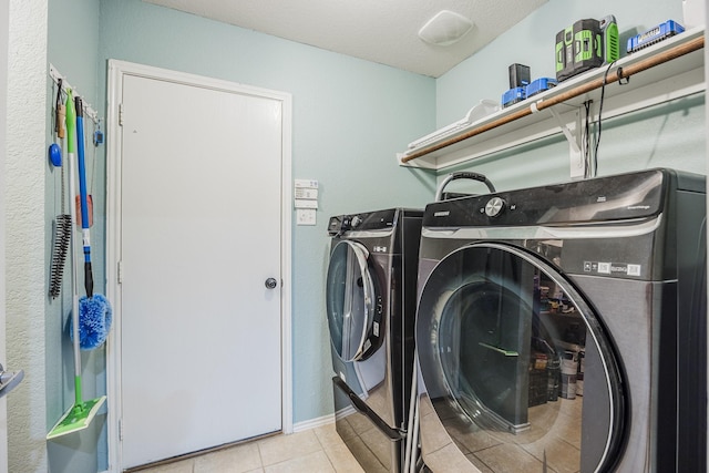 3428 Baby Doe Ct, Fort Worth, TX 76137 - laundry room with washing machine and clothes dryer, light tile patterned flooring, baseboards, and a textured ceiling