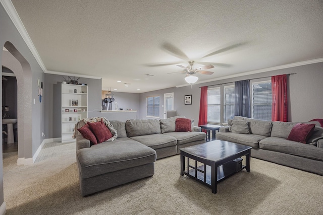 3428 Baby Doe Ct, Fort Worth, TX 76137 - living area with arched walkways, light colored carpet, a textured ceiling, crown molding, and ceiling fan