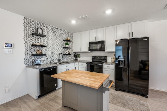 6851 Coulter Dr, Princeton, TX 75407 - kitchen featuring black appliances, open shelves, wooden counters, white cabinetry, and light wood-type flooring