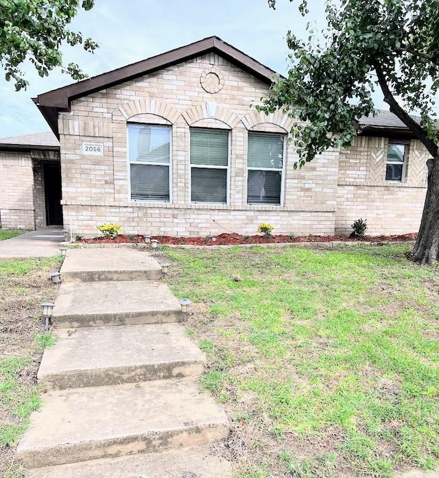 2056 Pecan Creek Dr, Mesquite, TX 75181 - view of front of property featuring a front lawn, stone siding, and brick siding