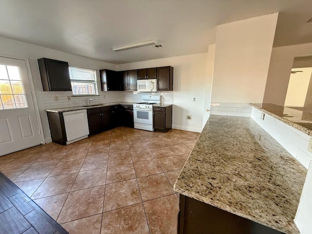 2056 Pecan Creek Dr, Mesquite, TX 75181 - kitchen featuring white appliances, a sink, tasteful backsplash, light tile patterned floors, and light stone countertops