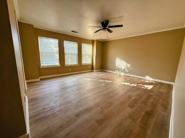 2056 Pecan Creek Dr, Mesquite, TX 75181 - unfurnished room featuring ceiling fan, ornamental molding, wood finished floors, and baseboards