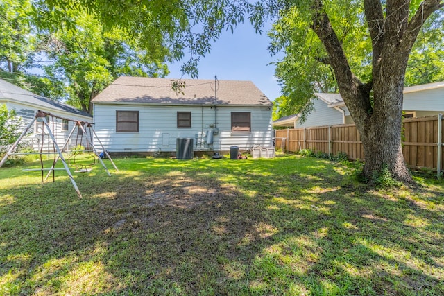 1213 Pine St, Grand Prairie, TX 75050 - back of house featuring a playground, crawl space, and central AC