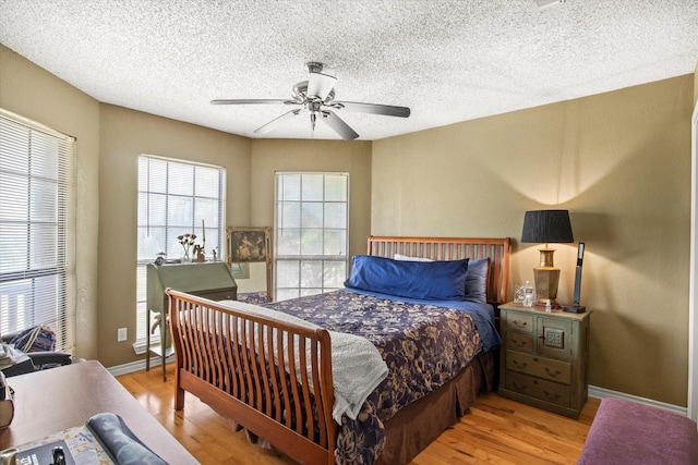 1578 Stainback Rd, Red Oak, TX 75154 - bedroom featuring light wood-style flooring, a textured ceiling, a ceiling fan, and baseboards