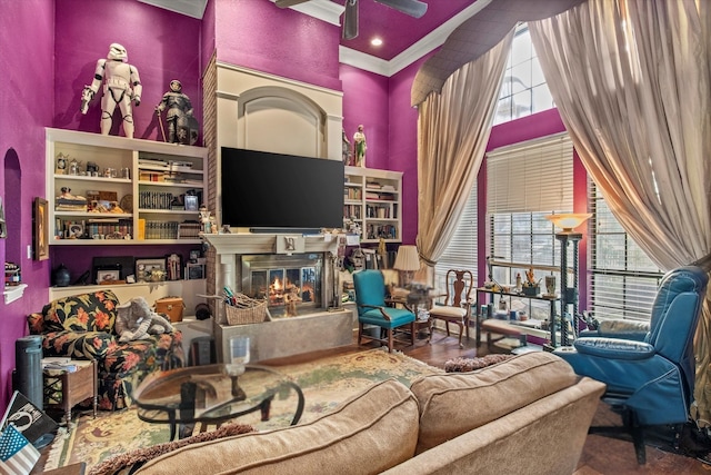 1578 Stainback Rd, Red Oak, TX 75154 - living area featuring a towering ceiling, a glass covered fireplace, ceiling fan, and crown molding