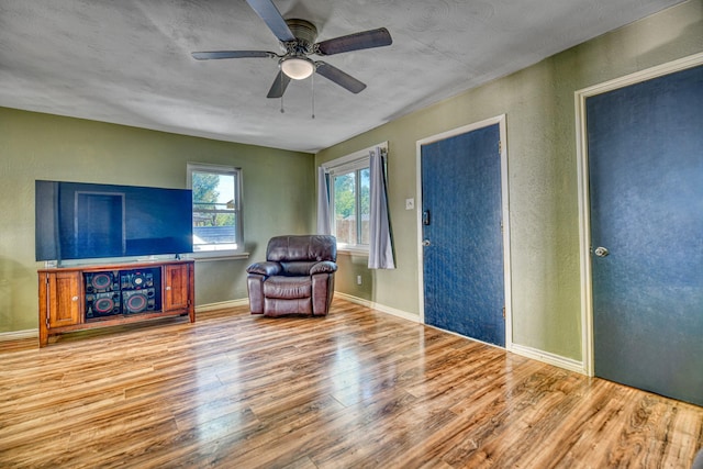 517 Pleasant Oaks Dr, Dallas, TX 75217 - living area with wood finished floors, a ceiling fan, baseboards, and a textured wall