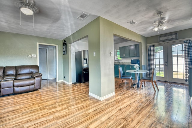 517 Pleasant Oaks Dr, Dallas, TX 75217 - living area with ceiling fan, light wood-type flooring, baseboards, and french doors