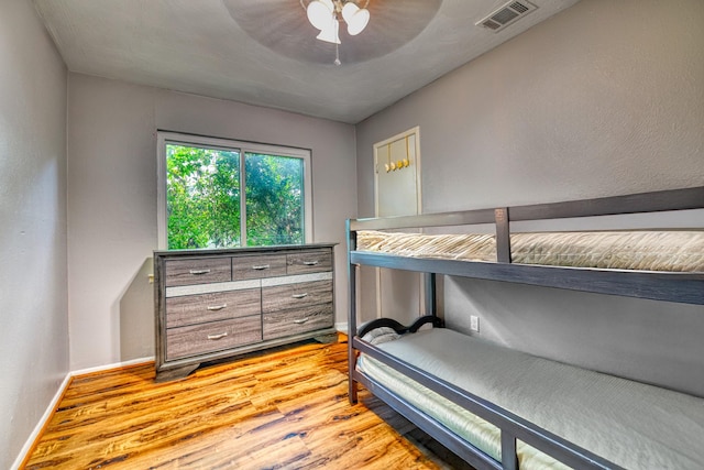 517 Pleasant Oaks Dr, Dallas, TX 75217 - bedroom featuring light wood-style flooring, baseboards, and ceiling fan