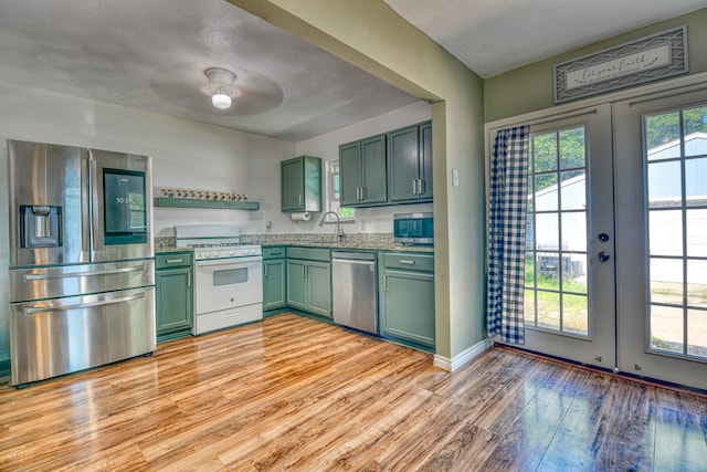 517 Pleasant Oaks Dr, Dallas, TX 75217 - kitchen featuring stainless steel appliances, green cabinets, french doors, and light wood-type flooring