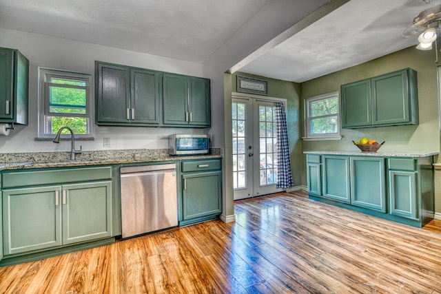 517 Pleasant Oaks Dr, Dallas, TX 75217 - kitchen with green cabinetry, stainless steel appliances, a sink, light wood-style floors, and french doors
