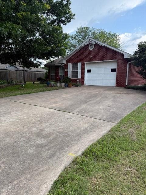 502 E College St, Leonard, TX 75452 - view of side of property featuring driveway, brick siding, and an attached garage