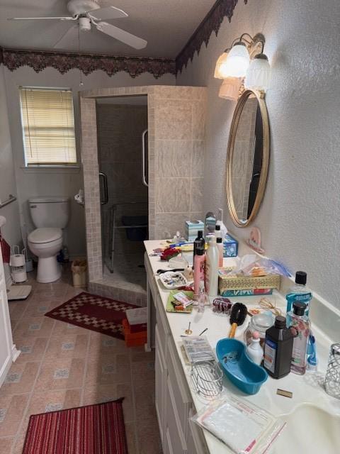 502 E College St, Leonard, TX 75452 - full bathroom featuring ceiling fan, a stall shower, toilet, and vanity