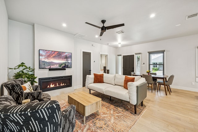 1921 Washington Ave, Fort Worth, TX 76110 - living area with ceiling fan, wood finished floors, a lit fireplace, and recessed lighting