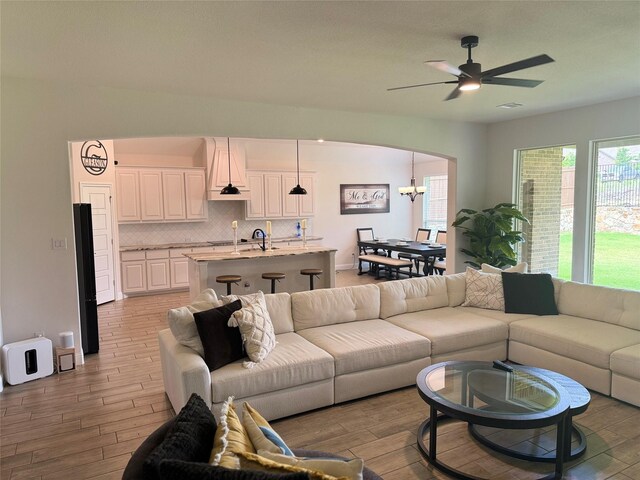 701 Winecup Way, Midlothian, TX 76065 - living area featuring arched walkways, light wood-type flooring, and ceiling fan