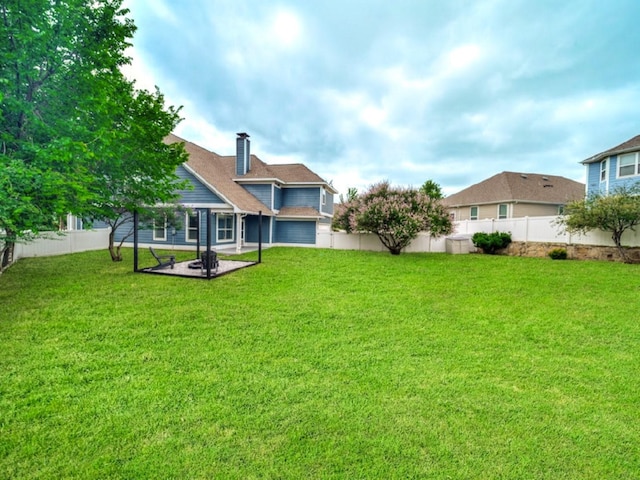 2028 Hartwell Ct, Providence Village, TX 76227 - back of property with a chimney, a fenced backyard, and a patio area