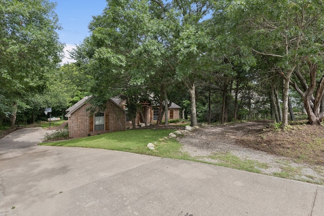 5321 Joe Wilson Rd, Midlothian, TX 76065 - view of property exterior with driveway, a yard, and brick siding