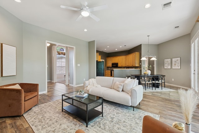 5321 Joe Wilson Rd, Midlothian, TX 76065 - living room featuring a ceiling fan, recessed lighting, and light wood-style flooring