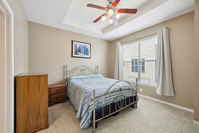 4121 Mckinney Ave Unit 21, Dallas, TX 75204 - bedroom with light carpet, a tray ceiling, and a ceiling fan
