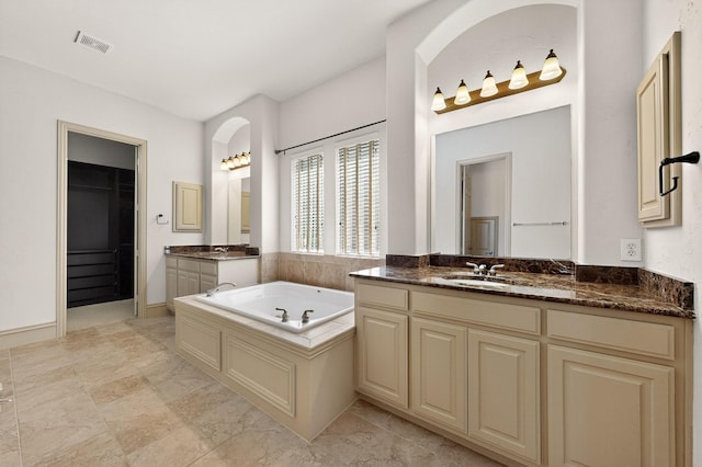 5766 Wellington Ln, Frisco, TX 75033 - bathroom featuring two vanities and a garden tub