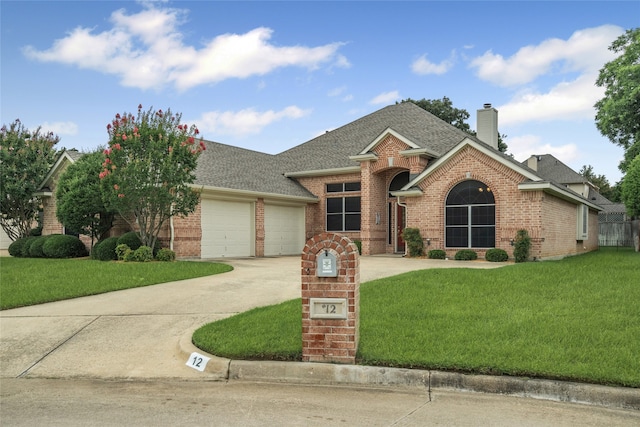 12 Equestrian Ct, Mansfield, TX 76063 - view of front facade with brick siding, an attached garage, a shingled roof, and a front lawn