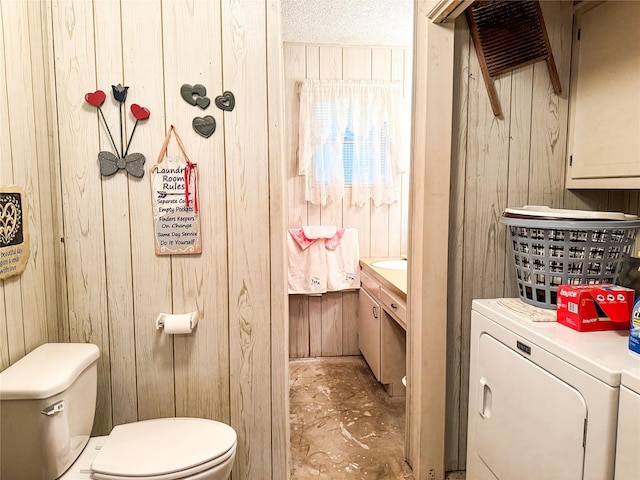 904 W 12th St, Cisco, TX 76437 - bathroom with separate washer and dryer, wooden walls, and vanity