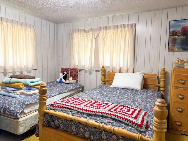 904 W 12th St, Cisco, TX 76437 - bedroom featuring a textured ceiling and wooden walls