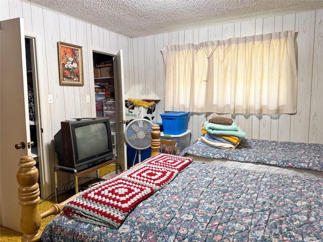 904 W 12th St, Cisco, TX 76437 - carpeted bedroom with a textured ceiling and wooden walls