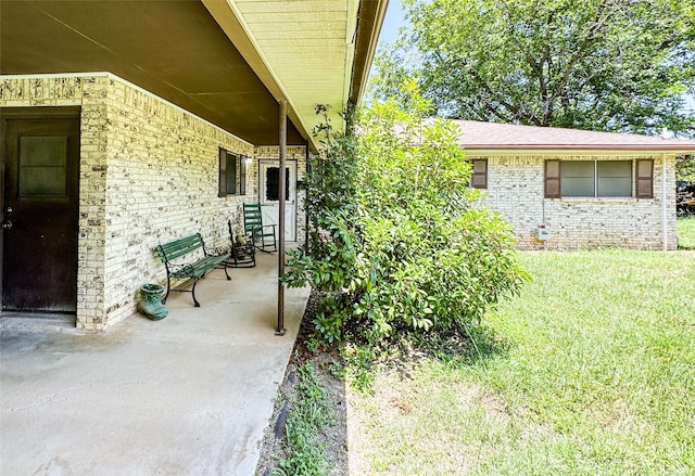 904 W 12th St, Cisco, TX 76437 - doorway to property featuring brick siding and a lawn