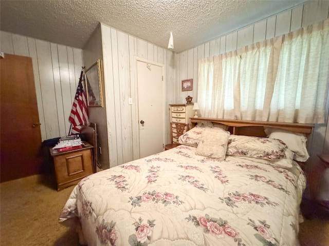 904 W 12th St, Cisco, TX 76437 - bedroom featuring carpet floors, a textured ceiling, wooden walls, and a closet