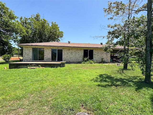 904 W 12th St, Cisco, TX 76437 - rear view of property with a lawn, a patio area, and brick siding