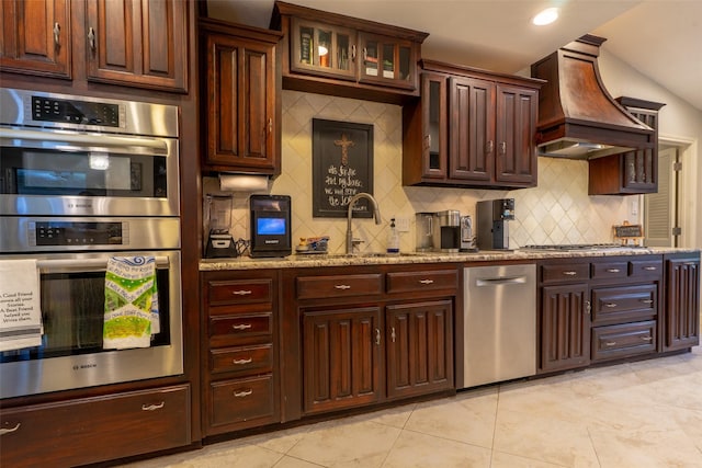 1104 Chesterton Dr, Richardson, TX 75080 - kitchen with stainless steel appliances, backsplash, custom exhaust hood, light tile patterned flooring, and light stone countertops