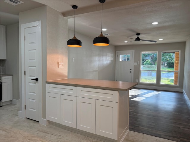 7118 Arborcrest Dr, Dallas, TX 75232 - kitchen with a peninsula, white cabinetry, ceiling fan, recessed lighting, and decorative light fixtures