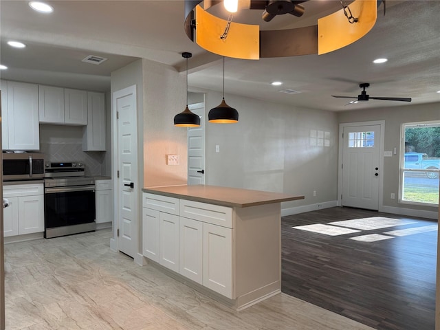 7118 Arborcrest Dr, Dallas, TX 75232 - kitchen featuring appliances with stainless steel finishes, ceiling fan, a peninsula, recessed lighting, and backsplash