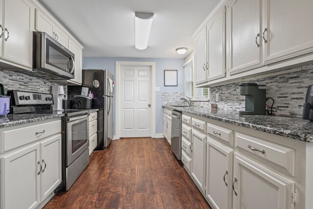 211 Second St, Denton, TX 76201 - kitchen with stainless steel appliances, tasteful backsplash, white cabinetry, and dark wood-type flooring