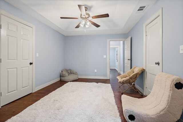 211 Second St, Denton, TX 76201 - living area with a tray ceiling, a ceiling fan, and dark wood-style floors